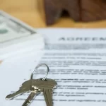 Image of a set of keys, stack of money, and purchase agreement, used for a blog for required forms for trailer purchases for Appalachian Trailers